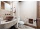 Modern powder room featuring a copper sink and stone tile at 22759 Mountain Spirit Way, Indian Hills, CO 80454