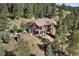 Aerial view of house with large deck and playground at 22759 Mountain Spirit Way, Indian Hills, CO 80454