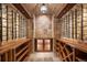 Impressive wine cellar with stone walls and ample storage at 22759 Mountain Spirit Way, Indian Hills, CO 80454