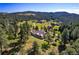 Aerial view of house nestled in a mountain setting at 22759 Mountain Spirit Way, Indian Hills, CO 80454