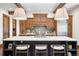 Gourmet kitchen boasts custom wood cabinets, expansive island, and high-end appliances at 22759 Mountain Spirit Way, Indian Hills, CO 80454