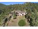 Aerial view of home's back, showcasing the deck and yard at 22759 Mountain Spirit Way, Indian Hills, CO 80454