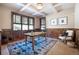 Home office with built-in wood features and large windows at 22759 Mountain Spirit Way, Indian Hills, CO 80454