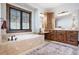 Bathroom with soaking tub, custom cabinetry, and rug at 22759 Mountain Spirit Way, Indian Hills, CO 80454