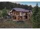 Multi-level home with stone accents, situated on a hillside with mountain backdrop at 22759 Mountain Spirit Way, Indian Hills, CO 80454