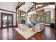 High-ceilinged living room with hardwood floors, stone fireplace and access to a deck at 22759 Mountain Spirit Way, Indian Hills, CO 80454