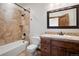 Bathroom with tile shower/tub combo and wood vanity at 22759 Mountain Spirit Way, Indian Hills, CO 80454