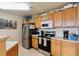 Well-equipped kitchen featuring stainless steel appliances and wood cabinets at 5703 N Gibralter Way # 204, Aurora, CO 80019