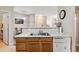 Kitchen with double sink, dishwasher, and view into living area at 5703 N Gibralter Way # 204, Aurora, CO 80019