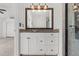 Bathroom with granite countertop, white cabinets, and a mirrored medicine cabinet at 9909 W 99Th Ave, Broomfield, CO 80021