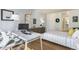 Well-lit bedroom with a home office setup and striped bedding at 3100 E Cherry Creek South Dr # 303, Denver, CO 80209