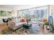 Living room with sofa, rug, and sliding glass doors to balcony at 3100 E Cherry Creek South Dr # 303, Denver, CO 80209