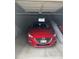 Image of a red car parked in an indoor parking garage at 3100 E Cherry Creek South Dr # 303, Denver, CO 80209
