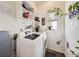 Bright laundry room with washer, dryer, and extra shelving at 4635 Crestone Peak St, Brighton, CO 80601