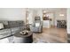 Open living room with gray couch, recliner, and coffee table, hardwood floors at 15700 E Jamison Dr # 8-103, Englewood, CO 80112