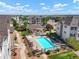 Community pool and spa with surrounding buildings at 15700 E Jamison Dr # 8-103, Englewood, CO 80112