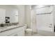 Clean bathroom with granite vanity, bathtub, and shower at 15700 E Jamison Dr # 8-103, Englewood, CO 80112