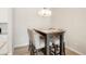 Dining area with dark brown table and four gray upholstered chairs at 15700 E Jamison Dr # 8-103, Englewood, CO 80112