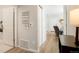 Bright hallway with wood-look floors and access to other rooms at 15700 E Jamison Dr # 8-103, Englewood, CO 80112