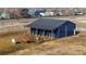 Horse barn with multiple stalls and covered area at 6073 County Road 20, Longmont, CO 80504