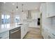 Bright kitchen with white cabinets, stainless steel appliances, and large island at 5072 Ditmars Ln, Castle Rock, CO 80104