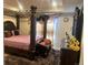 Spacious main bedroom with a large four-poster bed and an ensuite bathroom at 15600 Bolling Dr, Denver, CO 80239