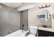 Basement bathroom with tiled shower/tub combo and granite vanity at 3350 Olive St, Denver, CO 80207