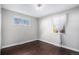 Bright bedroom featuring dark hardwood floors and a neutral color palette at 3350 Olive St, Denver, CO 80207