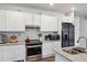 Modern kitchen with stainless steel appliances and white cabinets at 9283 Twenty Mile Rd # 207, Parker, CO 80134