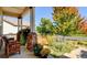 Inviting front porch with seating and colorful flowerpots at 4651 Belford Cir, Broomfield, CO 80023