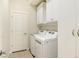 Convenient laundry room with washer, dryer, and storage at 2366 Primo Rd # 207, Highlands Ranch, CO 80129