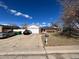 Ranch-style home with attached garage and solar panels at 13069 E Alaska Pl, Aurora, CO 80012