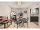 Bright dining area with metal table and chairs, and an adjacent kitchen at 387 Vaughn St, Aurora, CO 80011