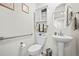 Clean bathroom with pedestal sink, toilet, and linen cabinet at 13352 Oneida St, Thornton, CO 80602