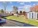 Fenced backyard with green grass, shed, playset, and deck at 12195 Grape St, Thornton, CO 80241