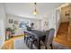 Dining area with hardwood floors, a large window, and a table with four chairs at 12195 Grape St, Thornton, CO 80241