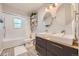 Updated bathroom with double sinks and a walk-in shower at 7761 W Ottawa Pl, Littleton, CO 80128