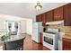 Kitchen with wood cabinets, gas range and refrigerator at 205 E 106Th Pl, Northglenn, CO 80233