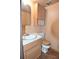 Small bathroom with wood cabinets and single sink at 1200 S Monaco St Pkwy # 31, Denver, CO 80224