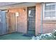 Brick building exterior with entrance and small patio area at 1200 S Monaco St Pkwy # 31, Denver, CO 80224