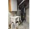 Unfinished basement with water heater and utilities at 9934 Grove St # C, Westminster, CO 80031