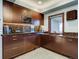 Basement wet bar with granite countertops and modern cabinetry at 24503 Chris Dr, Evergreen, CO 80439