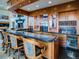 Home bar with granite countertop and wine storage at 24503 Chris Dr, Evergreen, CO 80439