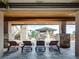 Covered patio with seating area, mountain views, and outdoor fireplace at 24503 Chris Dr, Evergreen, CO 80439