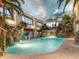 Indoor pool oasis with waterfall feature, lush landscaping, and palm trees at 24503 Chris Dr, Evergreen, CO 80439