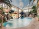 Indoor pool oasis with waterfall feature, lush landscaping, and palm trees at 24503 Chris Dr, Evergreen, CO 80439