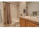 Clean bathroom with shower/tub combo and wood vanity at 427 S Quay St, Lakewood, CO 80226