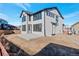 Two-story house with gray siding, dark trim, and a patio at 459 Muirfield Cir, Louisville, CO 80027