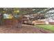Landscaped yard with large tree and wooden fence at 8120 S Jay Dr, Littleton, CO 80128