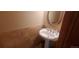 Small bathroom with pedestal sink and tiled walls at 8120 S Jay Dr, Littleton, CO 80128